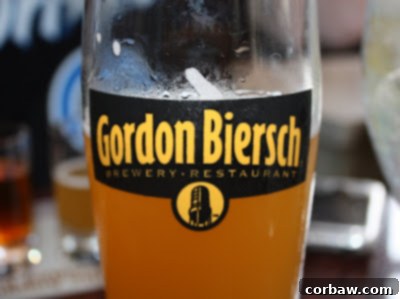 A tall glass of effervescent Hefeweizen beer at Gordon Biersch, with a citrus garnish