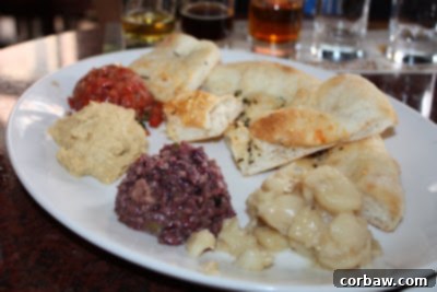 A vibrant plate of assorted tapas, featuring various small dishes and appetizers for sharing