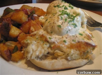 A gourmet Eggs Chesapeake dish, featuring poached eggs, a jumbo lump crab cake, and English muffin with sauce