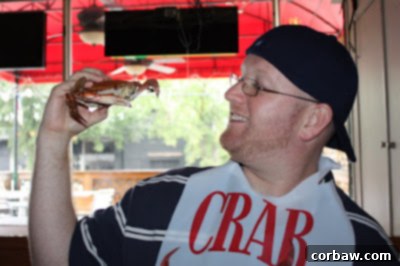 Hands demonstrating the art of cracking open a steamed blue crab to extract the meat
