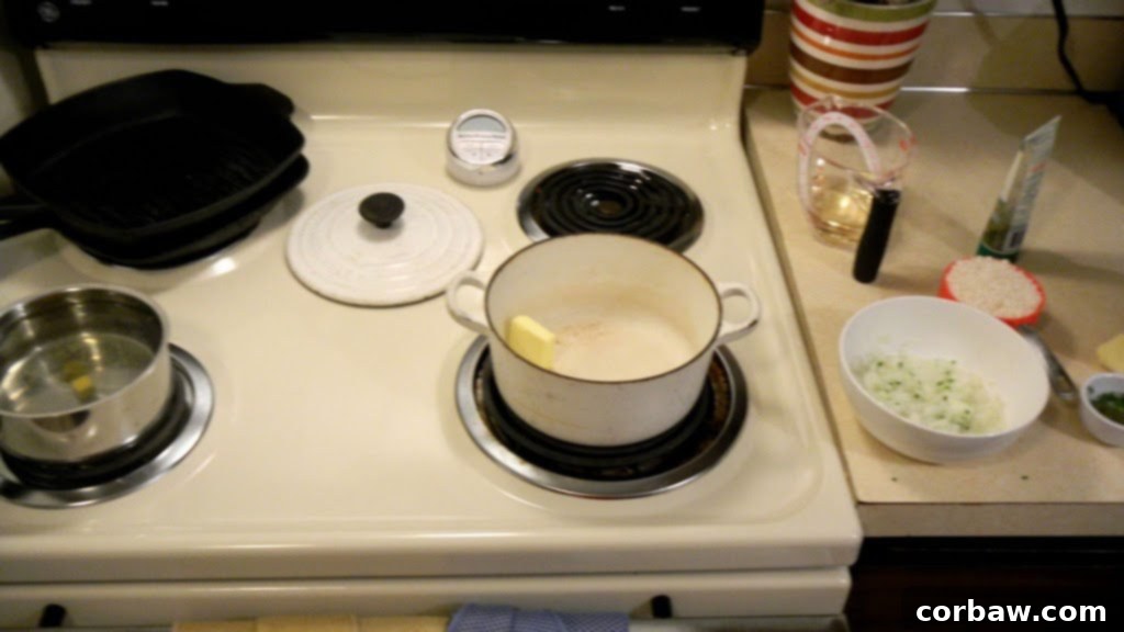 Finely diced onions and minced chives on a cutting board, ready for the risotto.