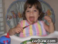 Two cheerful children holding small, individual lasagna rolls, smiling.