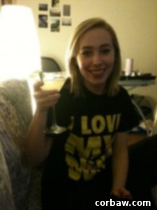 A woman smiling and holding a margarita glass.