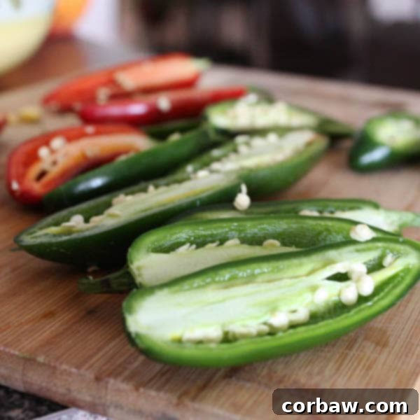 Fresh jalapeno peppers cut in half, showing seeds and membranes before cleaning