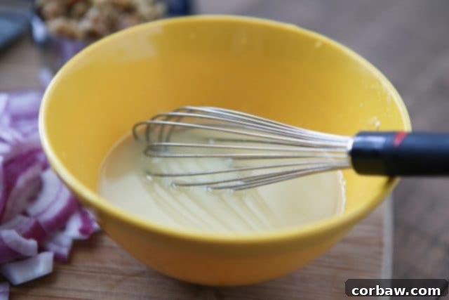 Serving of Green Bean Salad with Feta and Lemon Vinaigrette Green Bean Salad with Feta, walnuts, and red onion in a serving bowl
