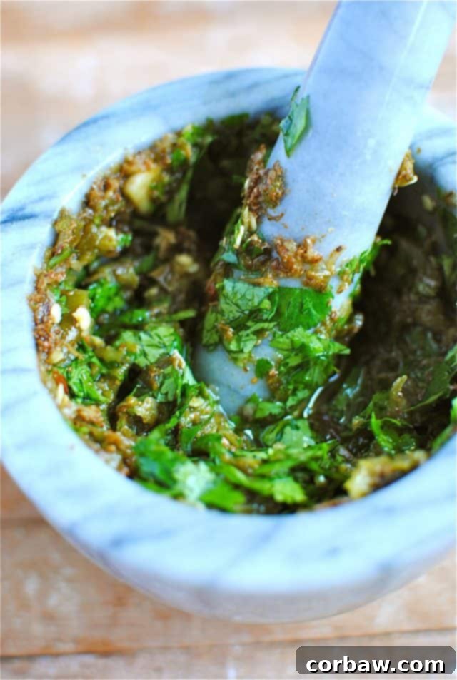 Final shrimp marinade with cilantro and olive oil mixed in a mortar