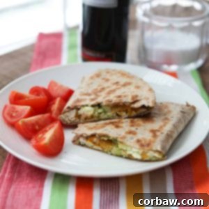 A perfectly cooked pesto chicken quesadilla, golden brown and crispy, ready to be cut and served.