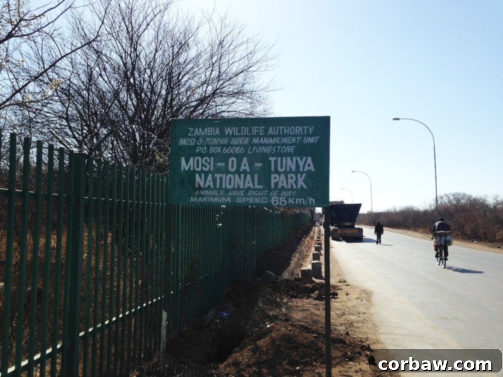 Sign for Mosi-oa-Tunya National Park in Zambia, indicating the diverse wildlife in the area.