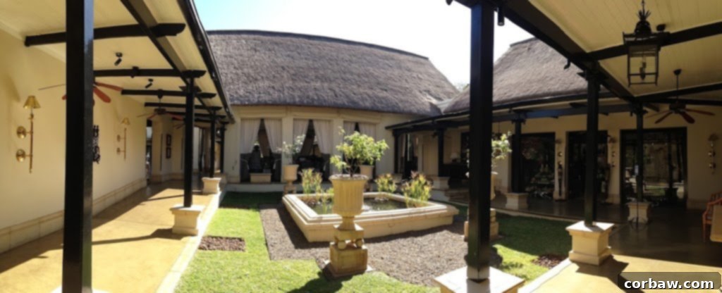 Another perspective of the Royal Livingstone Hotel, showcasing its grand architecture and beautiful setting.