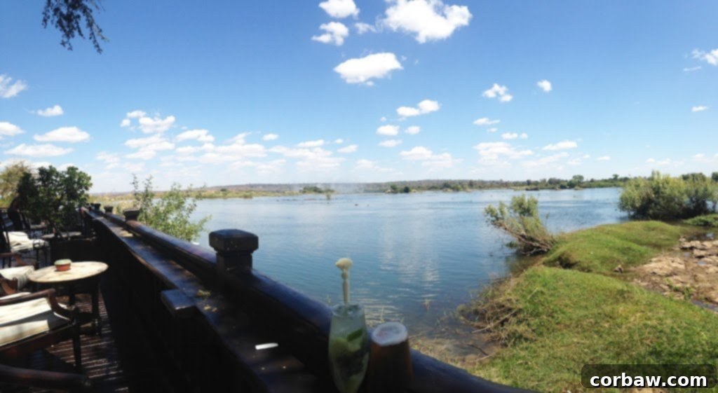 View from the Royal Livingstone Hotel deck overlooking the Zambezi River, with mist from Victoria Falls.