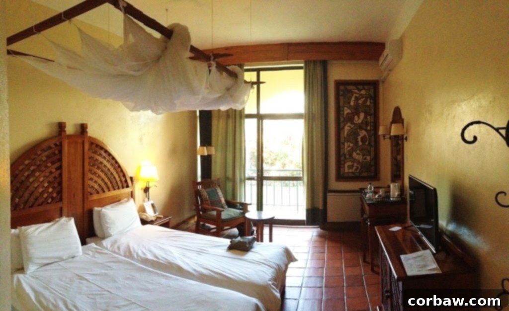 A comfortable hotel room at the Rainbow Hotel in Victoria Falls, Zimbabwe, ready for relaxation.