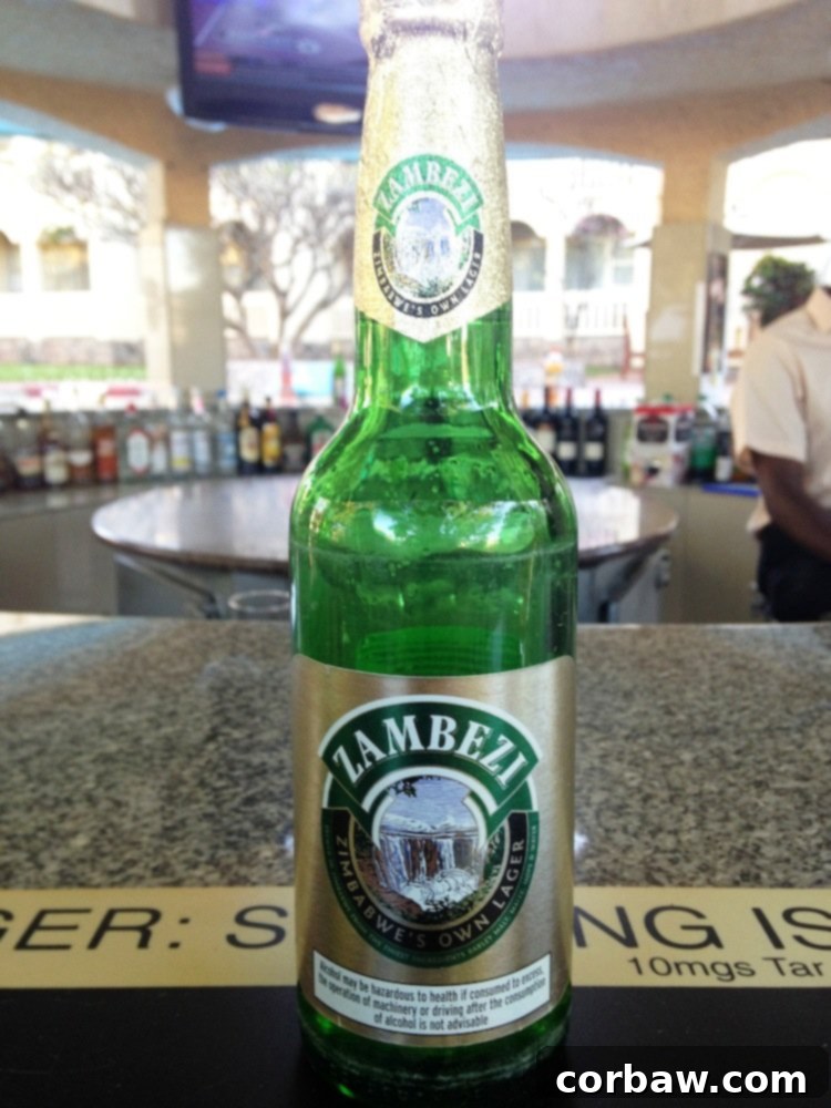 Fiancé enjoying a refreshing Zambezi Lager at the pool bar of the Rainbow Hotel, Victoria Falls.