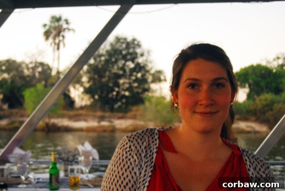 Author calming down on the Zambezi dinner cruise, enjoying a glass of wine after a stressful start.