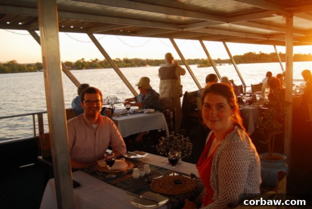 Fiancé laughing during the Zambezi River dinner cruise, enjoying the moment.