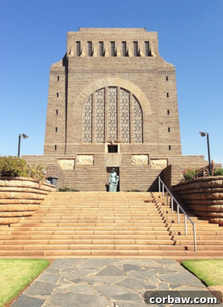 Bronze statue of a Voortrekker woman and two children at the entrance of the Voortrekker Monument.