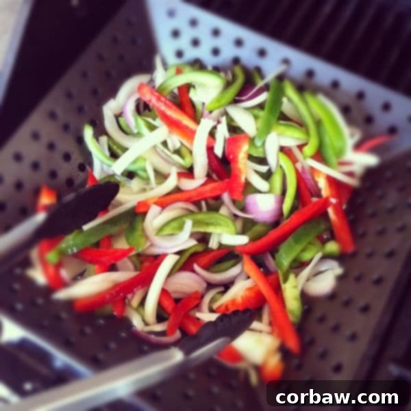 Grilled Chicken Sausage and Peppers Pita recipe2 Grill basket filled with colorful bell peppers and onions ready for cooking