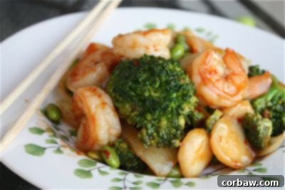 Plated Shrimp, Broccoli, and Edamame Stir Fry with chopsticks
