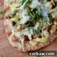 Grilled Summer Squash Pizza with a vibrant topping of squash, cheese, and basil