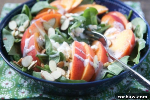 Spinach Salad with Peaches, Gorgonzola, and Almonds ingredients Close-up of a vibrant spinach salad with peach slices and blue cheese