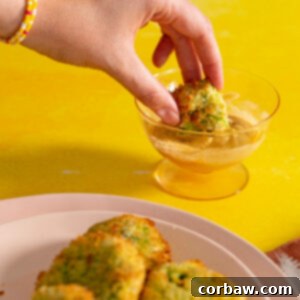 Mastering Steak Sides: 20+ Perfect Pairings and Pitfalls 16 Hand dipping air fried zucchini fritter into zesty dipping sauce with yellow background.