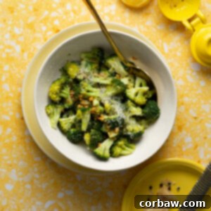 Mastering Steak Sides: 20+ Perfect Pairings and Pitfalls 19 Sous vide broccoli in white bowl on yellow background with parmesan and lemon slices.