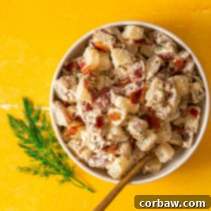 Mastering Steak Sides: 20+ Perfect Pairings and Pitfalls 3 Warm potato salad in white bowl on yellow surface with fresh herbs