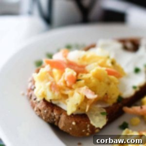 Smoked Salmon Scrambled Eggs presented in a bowl with fresh chives, ready to be enjoyed.