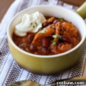 Red Chicken and Two-Bean Chili in a bowl with toppings