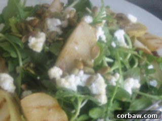 Beautifully plated mixed greens salad with grilled pears and goat cheese, ready to be enjoyed