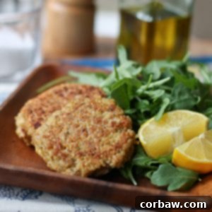 A close-up image of a perfectly cooked salmon quinoa cake, highlighting its golden-brown crust and fresh ingredients. This healthy 20-minute meal is ready to eat!