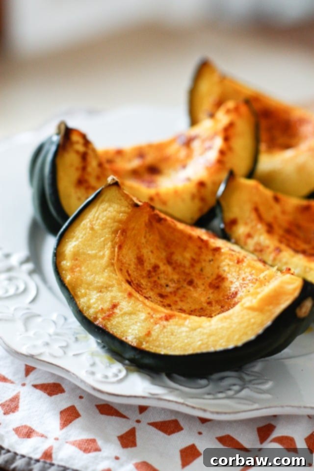 roasted acorn squash wedge on a white plate, beautifully seasoned with smoked paprika and ready to serve