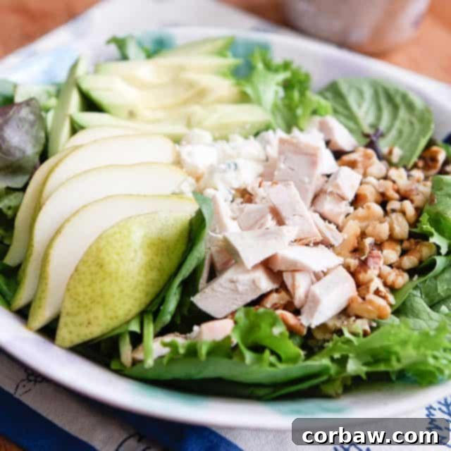 Chicken Pear and Avocado Salad close up of salad with pears, chopped rotisserie chicken, walnuts and avocado