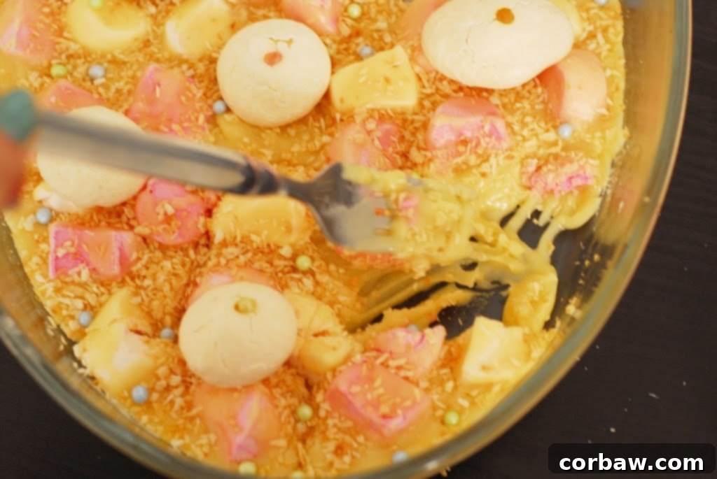 A close-up shot of the failed 'Easter Goo' dessert, a lumpy, unset marshmallow fudge mixture in a pan.