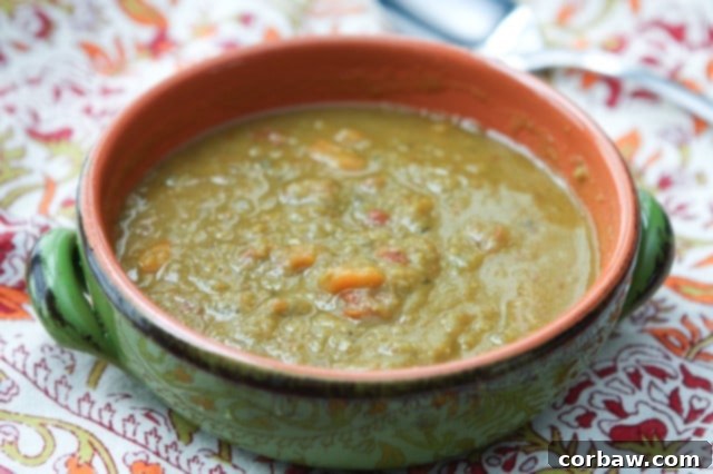 Slow Cooker Split Pea Soup bowl of split pea soup on fall colored table napkin with spoon in background