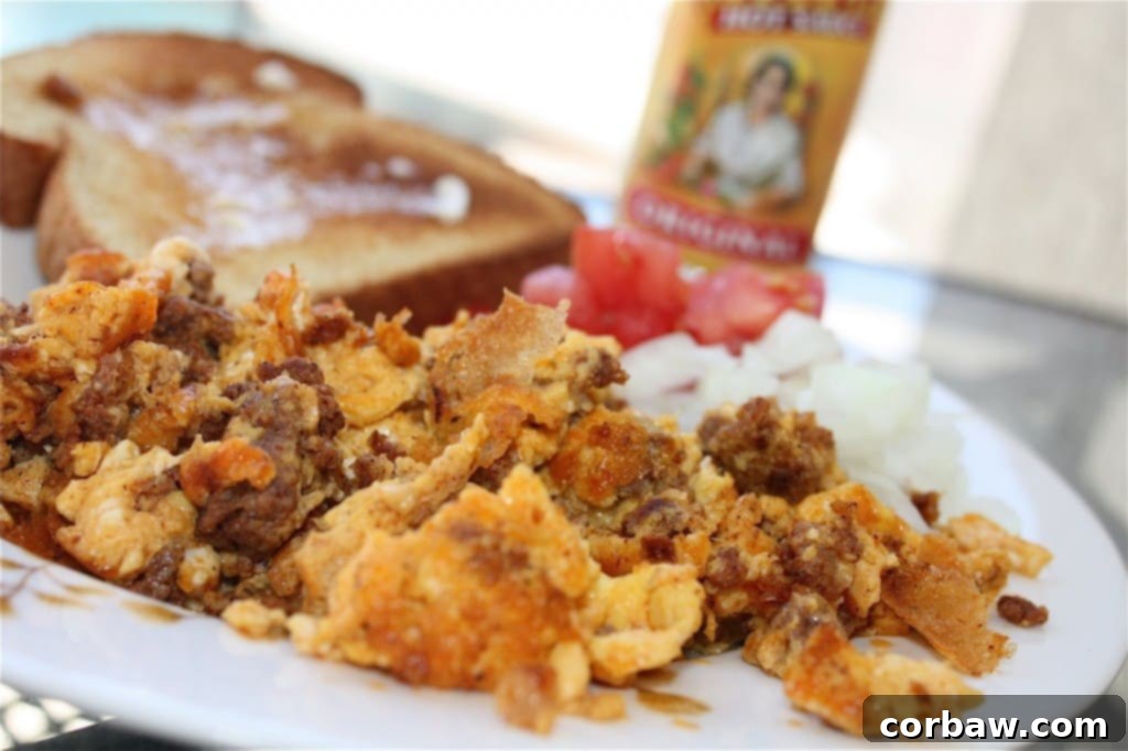 A tantalizing plate of Chorizo and Eggs, perfectly scrambled and ready to be served, garnished with fresh toppings, a spicy breakfast favorite.