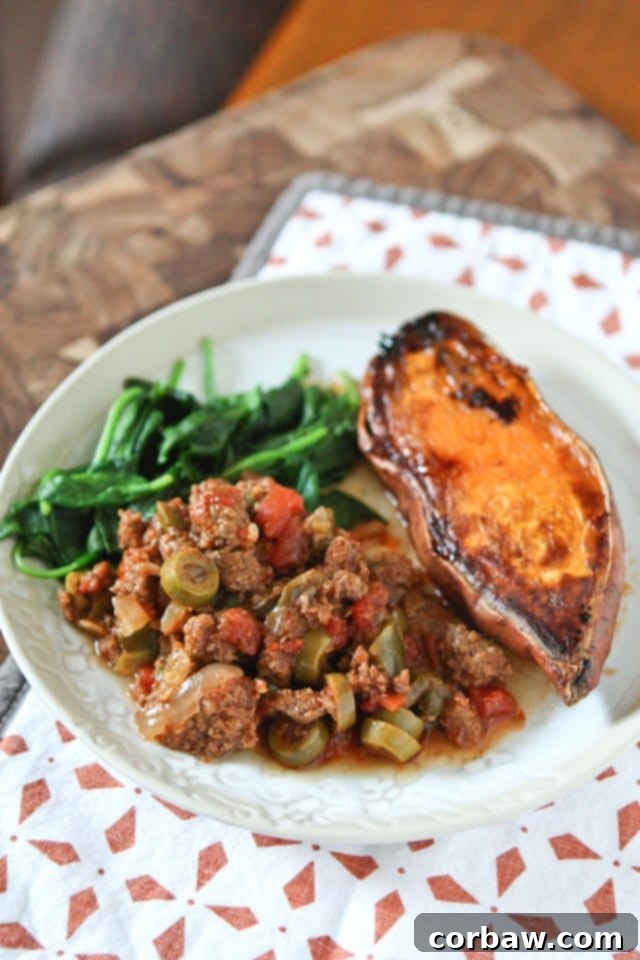 Ground beef and vegetables simmering in a new slow cooker with browning feature