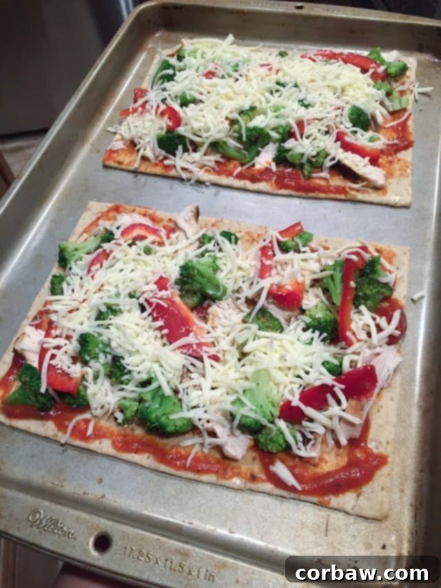 Savory Chicken, Broccoli and Red Pepper Flatbread Pizza 3 Close-up of a Chicken, Broccoli, and Red Pepper Flatbread Pizza slice