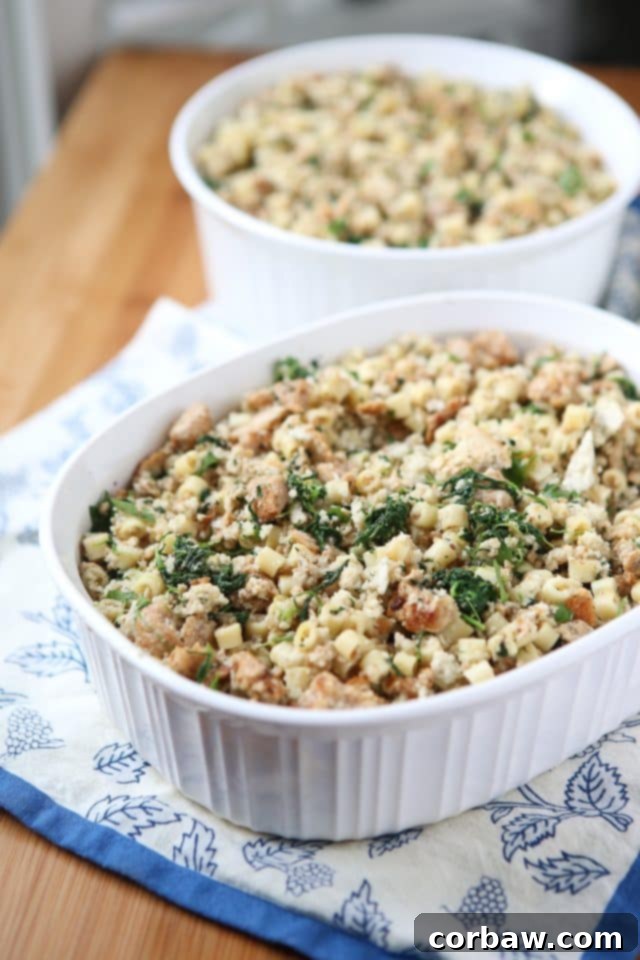 A Corningware baking dish filled with homemade Italian-style stuffing, featuring pasta, sausage, and spinach, ready for Thanksgiving dinner.