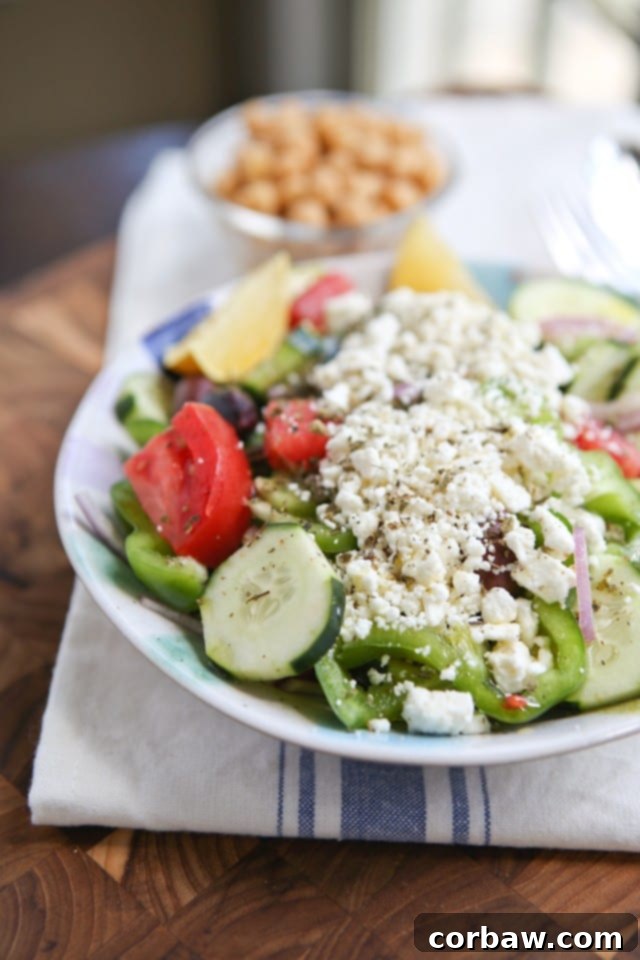 Freshly prepared Greek Village Salad with ripe tomatoes, cucumbers, and feta