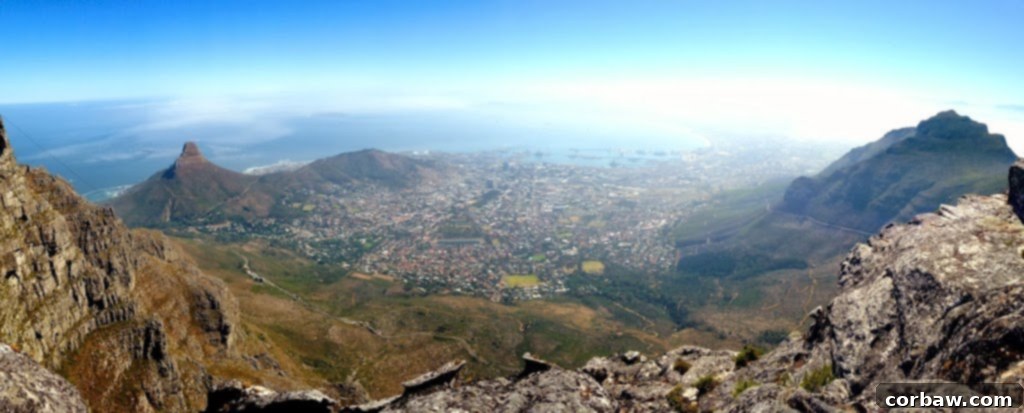 Fiancé posing on Table Mountain with Cape Town in the background