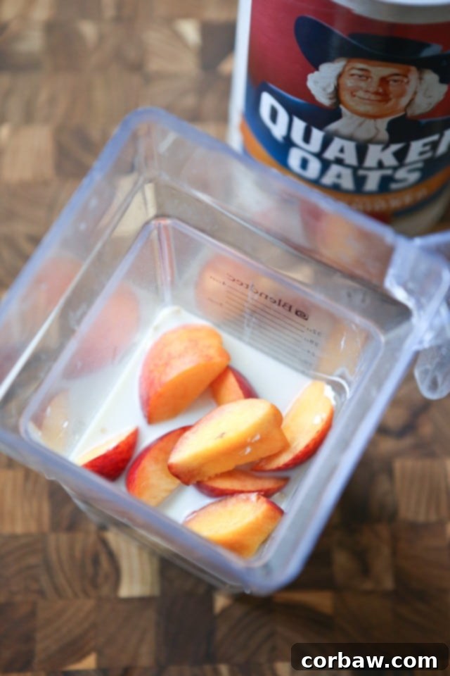 Close-up of a refreshing Peach Pie Smoothie in a glass with a straw
