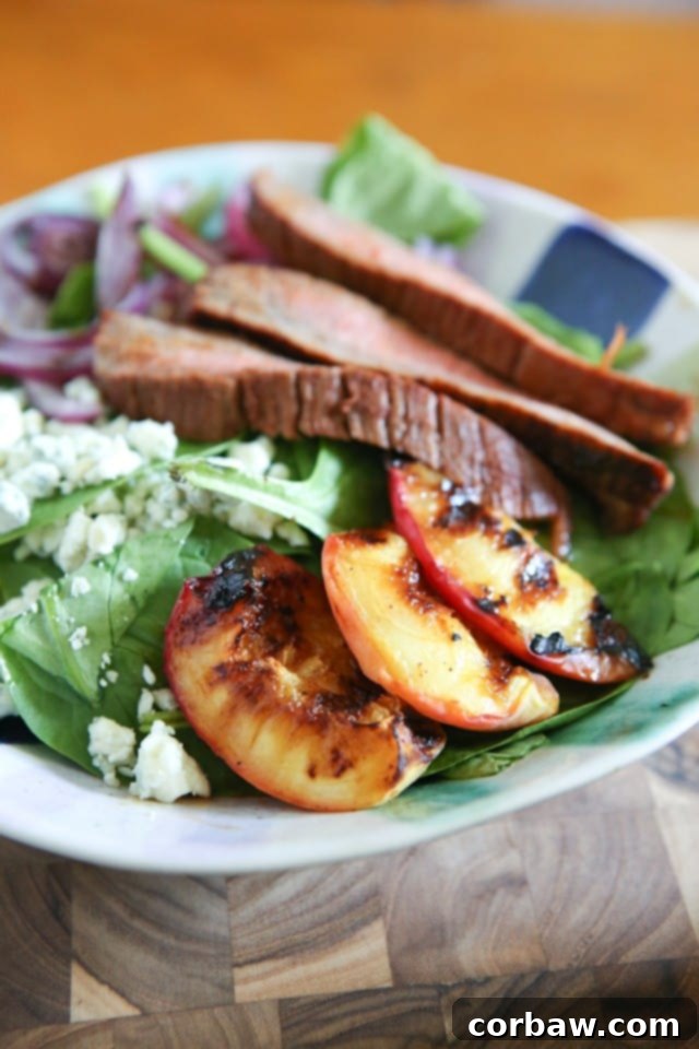 Steak Spinach Salad with Grilled Peaches and Red Onion